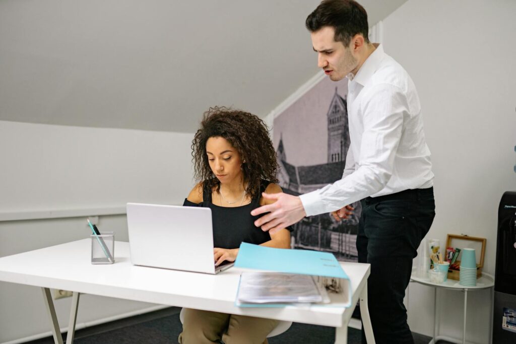 Manager and employee in discussion at the office, highlighting workplace dynamics.