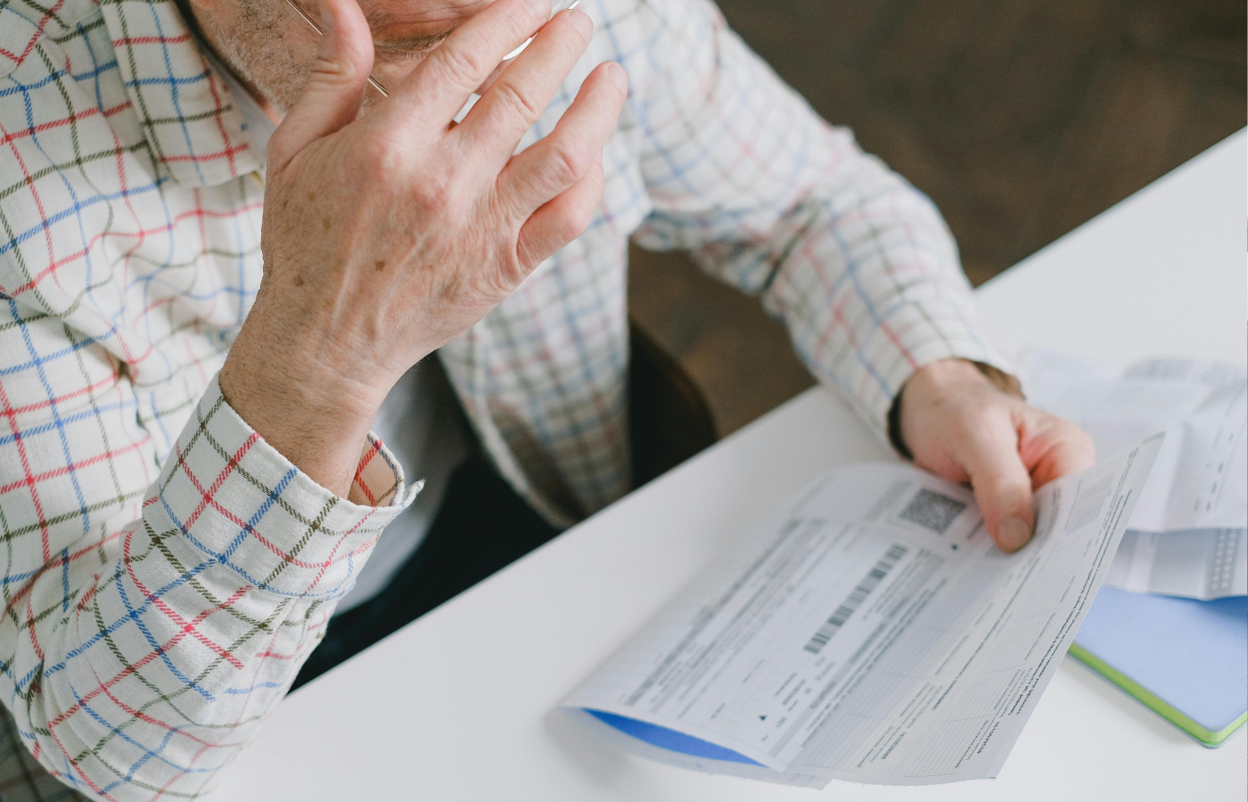 A old man looking concerned while reviewing rental costs
