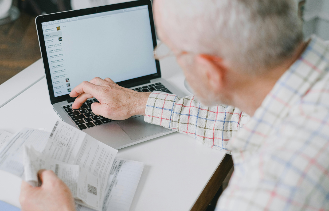A Man Typing on His Laptop while an empty retirement fund balance on their laptop