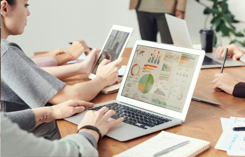 A data analyst charts and graphs in a business meeting
