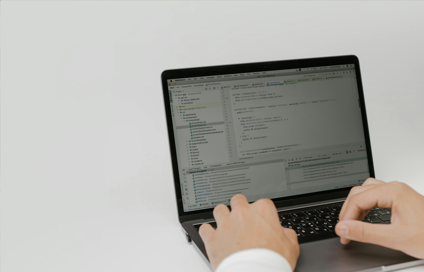 A computing engineer working on a laptop with a cloud network