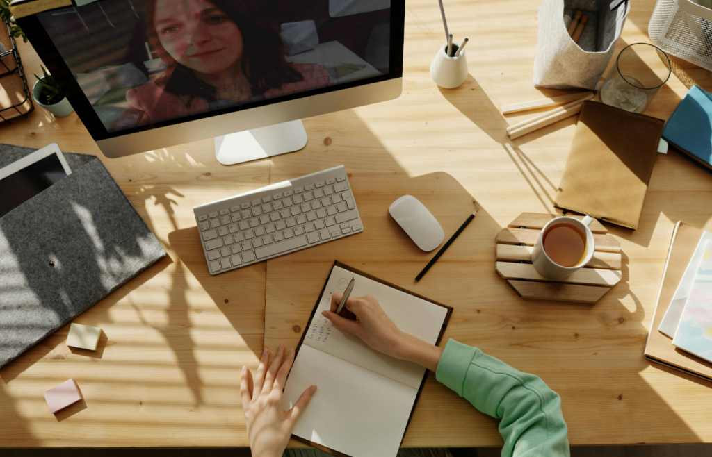 A young person at a desk and learning online