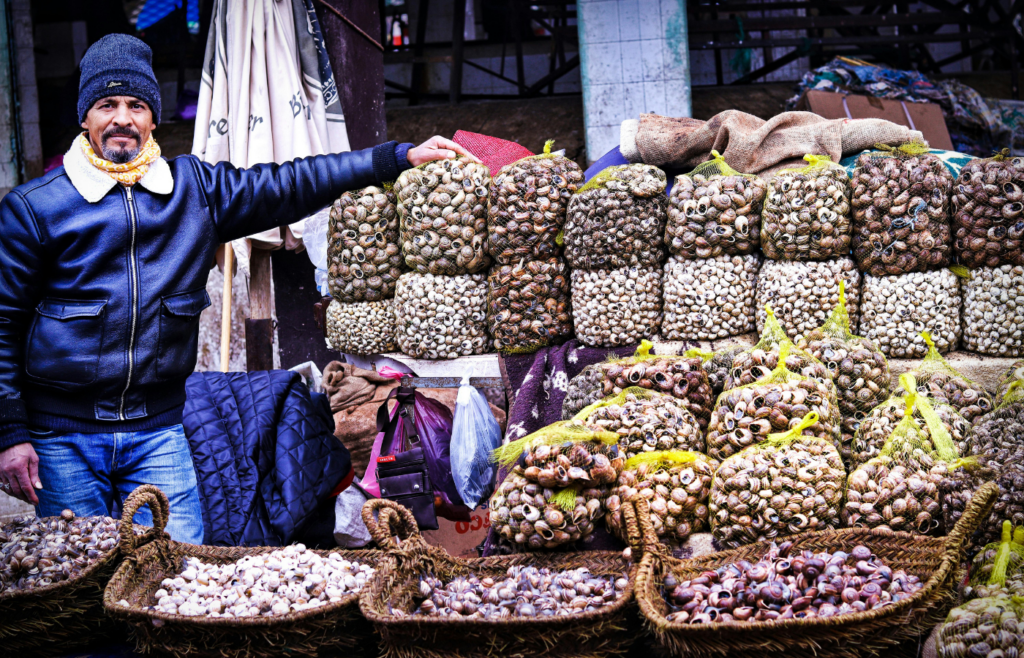 A small business owner standing in front of a store.