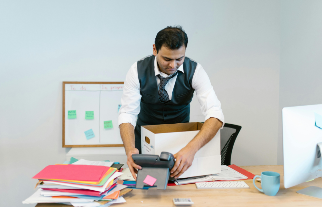 A person packing up an office desk