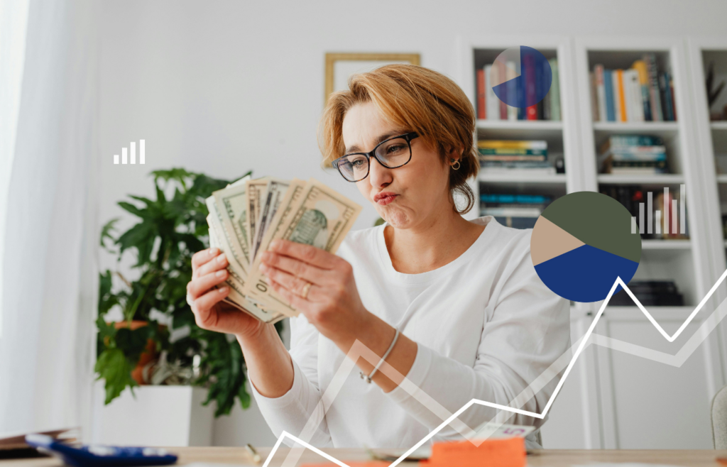 A person hesitating to invest a small stack of cash