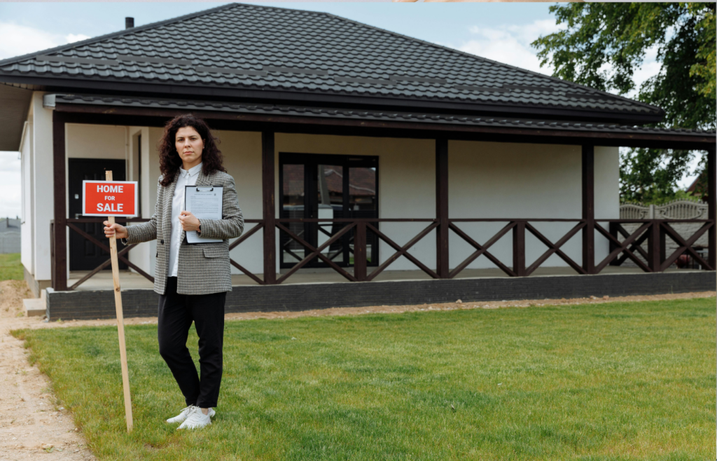 A Woman Standing on Green Grass Near the House
