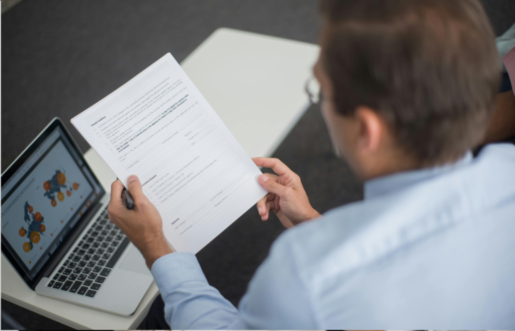 A professional looking disappointed while reviewing a paycheck