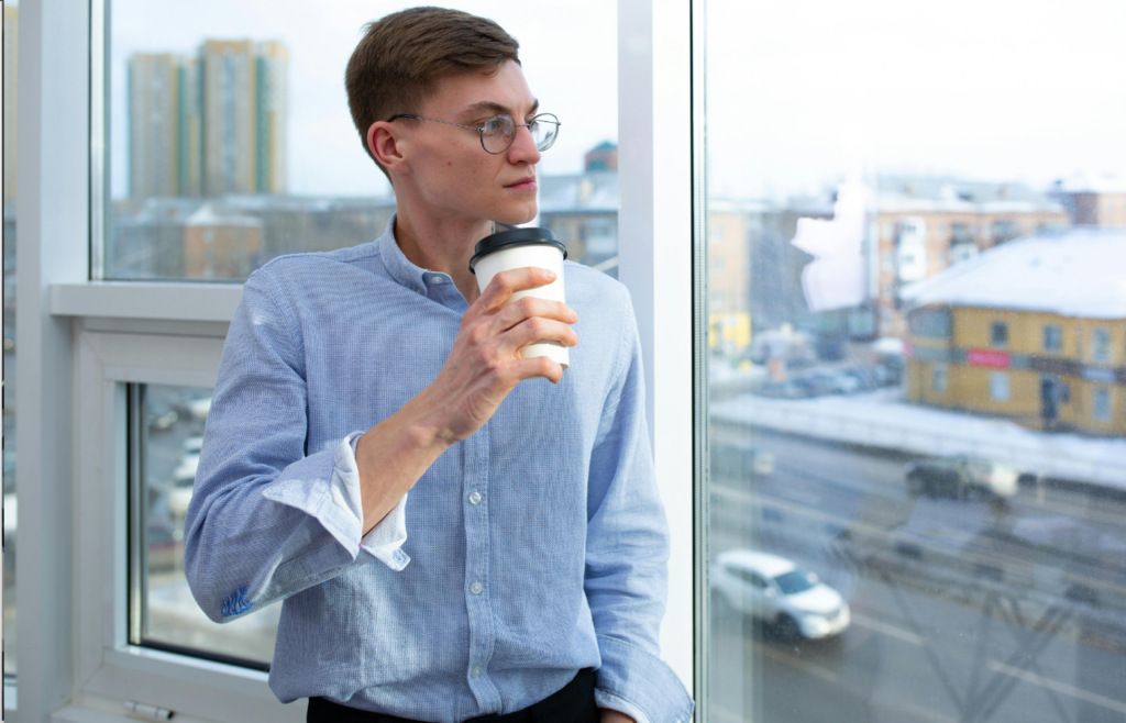 A Man Standing Beside the Window