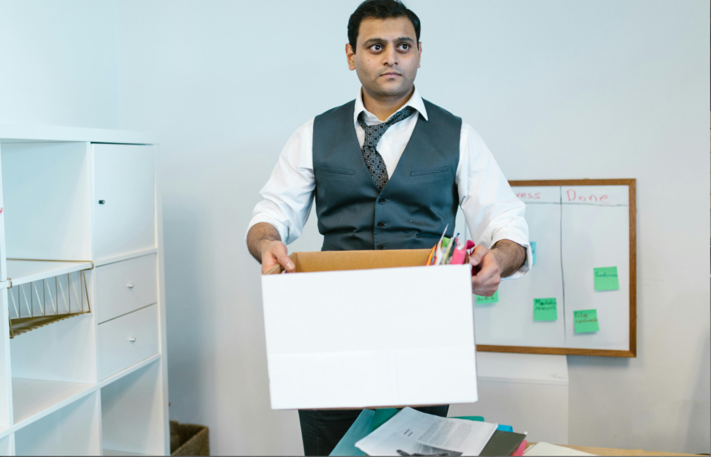 An employee packing up a box at their desk