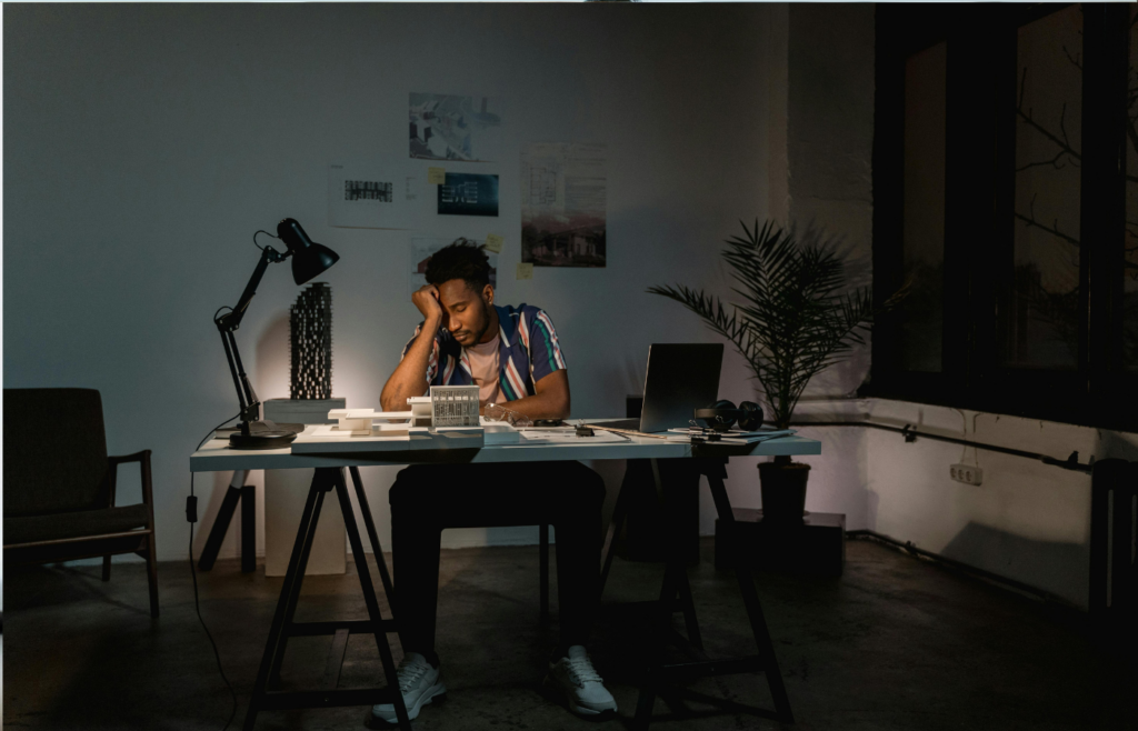 A tired employee working late in an empty office