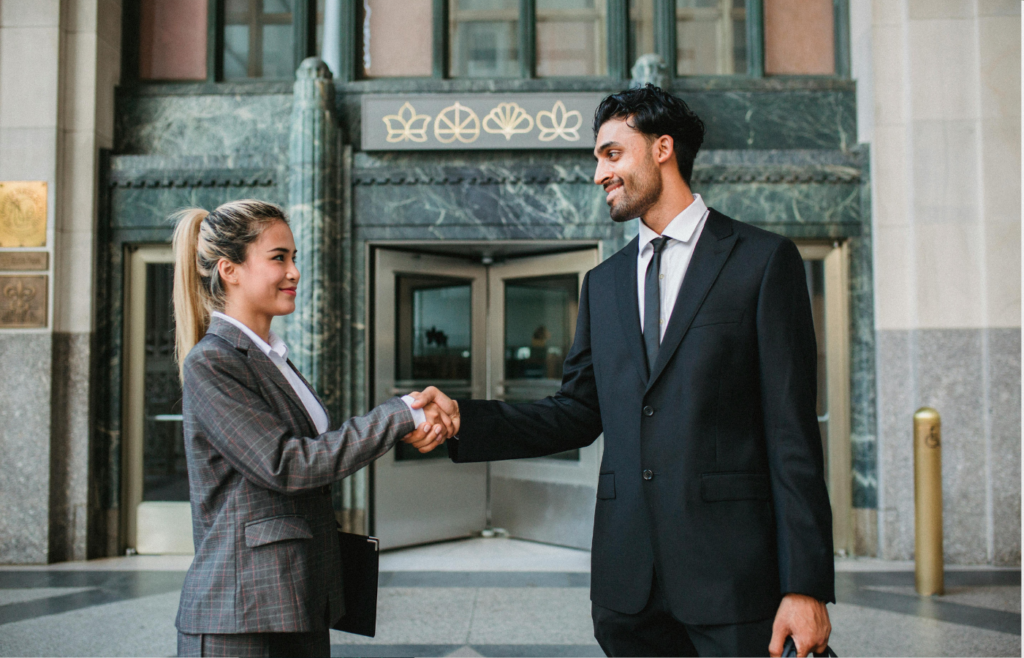 A boss shaking hands with one employee