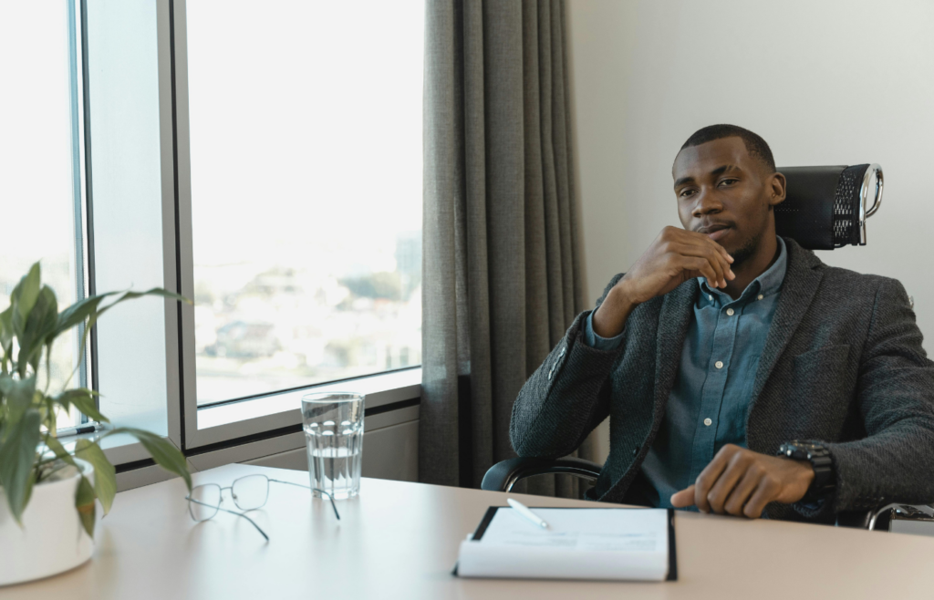 A professional sitting by a window, deep in thought