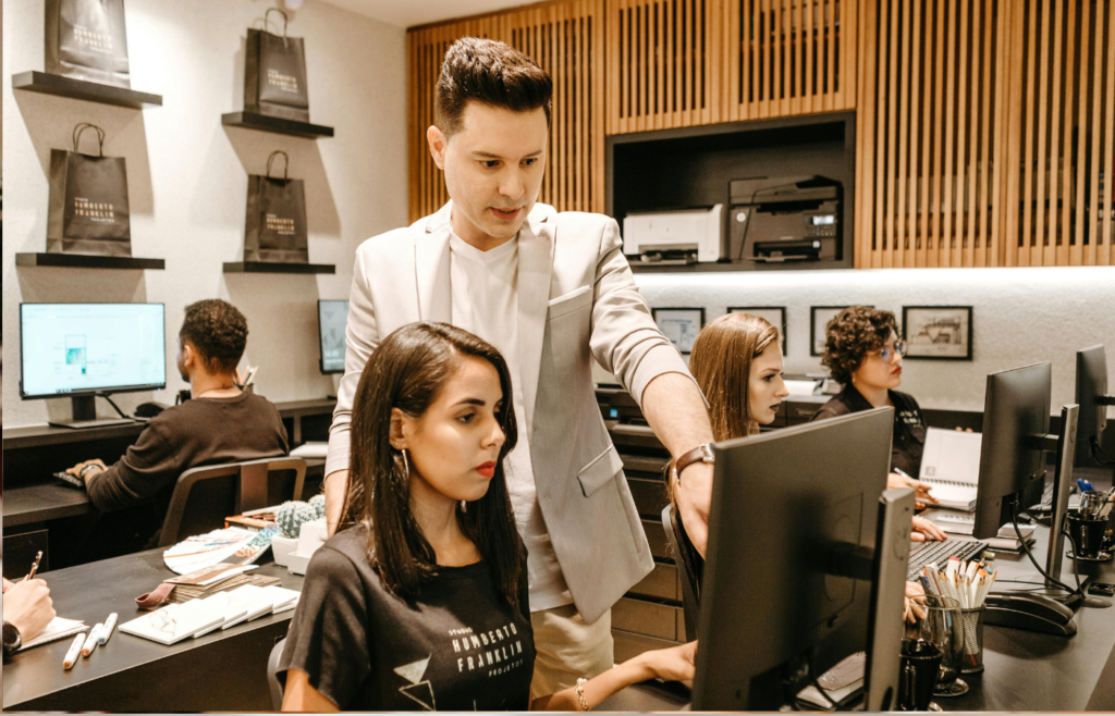 A mentor training a junior employee on a task
