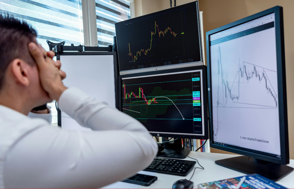A nervous investor watching a stock ticker drop.