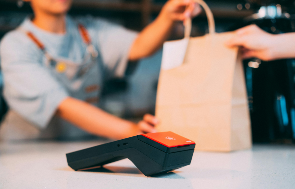 A person buying a bag with a credit card