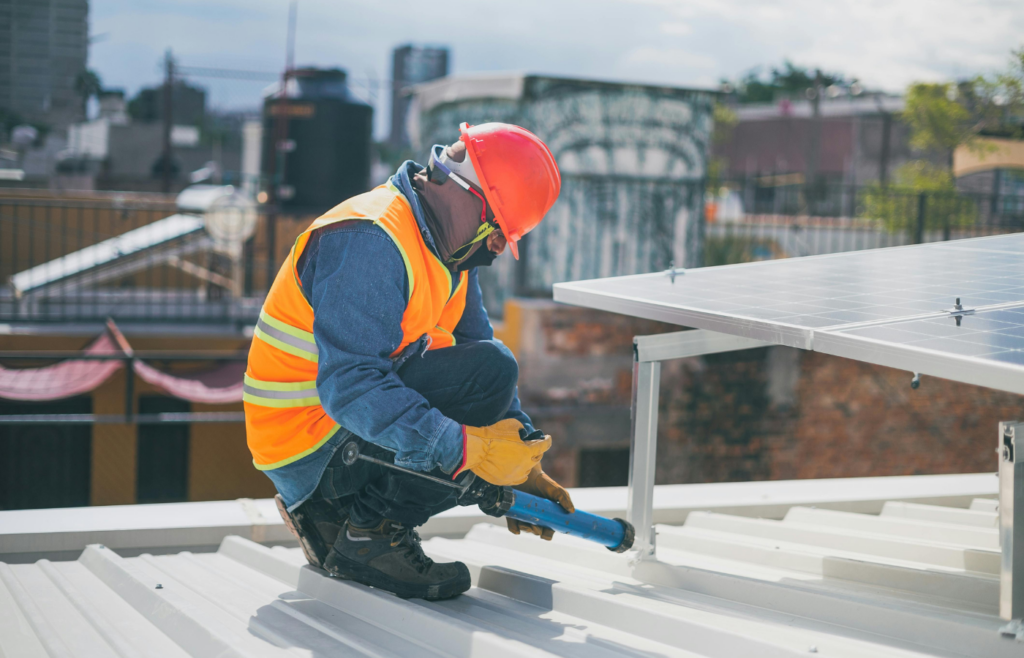 A technician installing solar panels on a rooftop