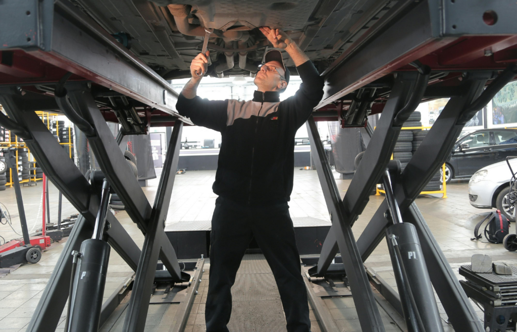 A technician repairing an car