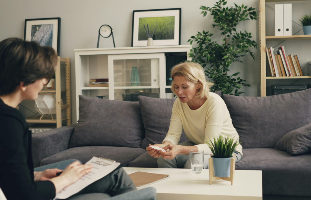 A therapist speaking with a patient in an home setting