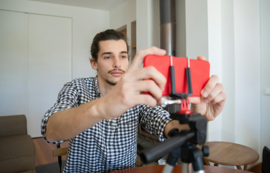 A Man Setting His Smartphone for Blogging