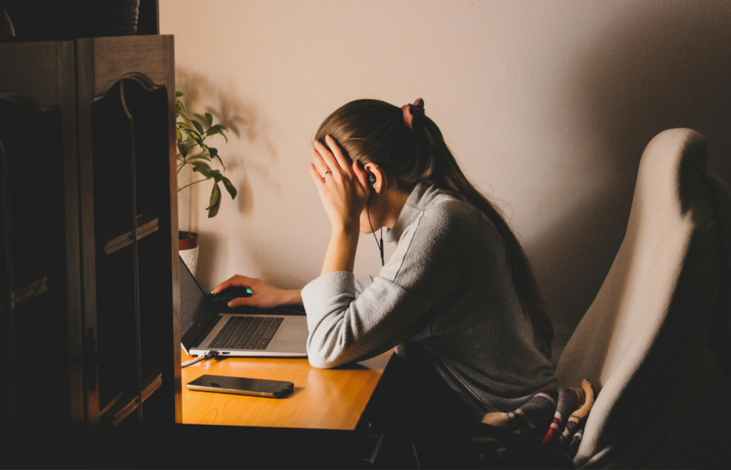 A woman Sitting on Chair in Front of Laptop Computer