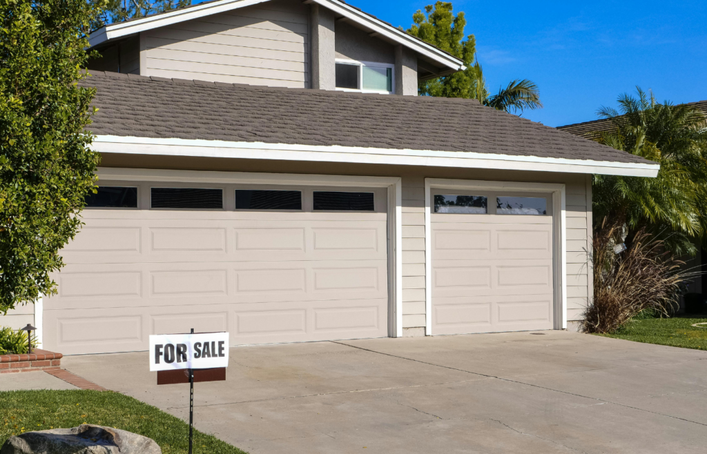 A “For Sale” sign in front of a home.