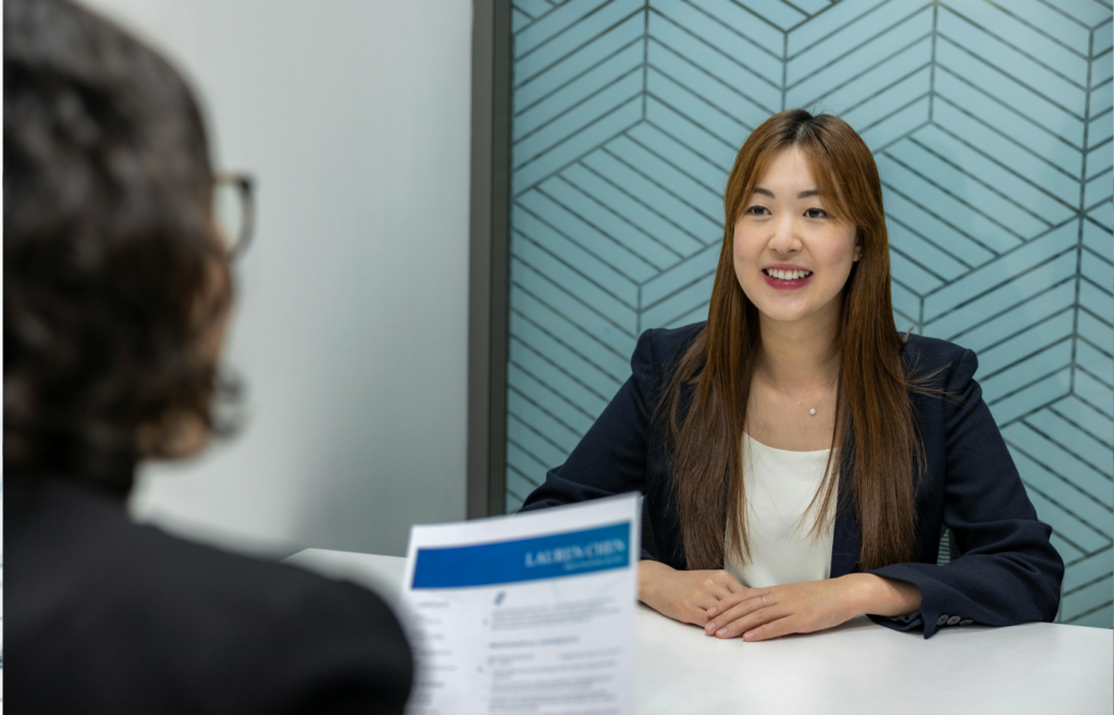 A job candidate smiling and speaking during an interview