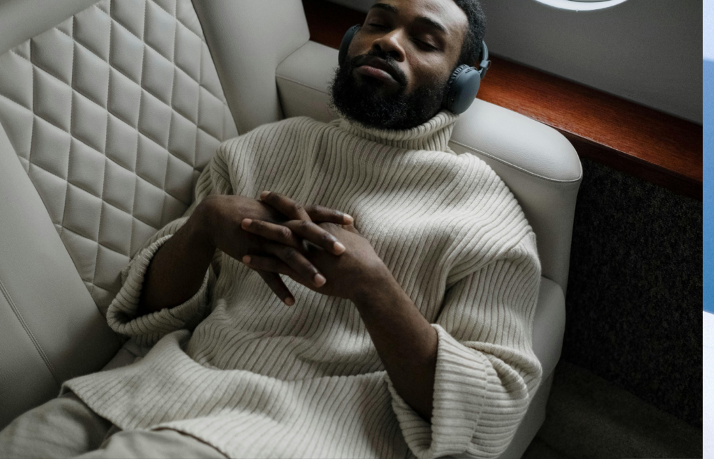 A relaxed traveler reclining in a spacious airplane seat