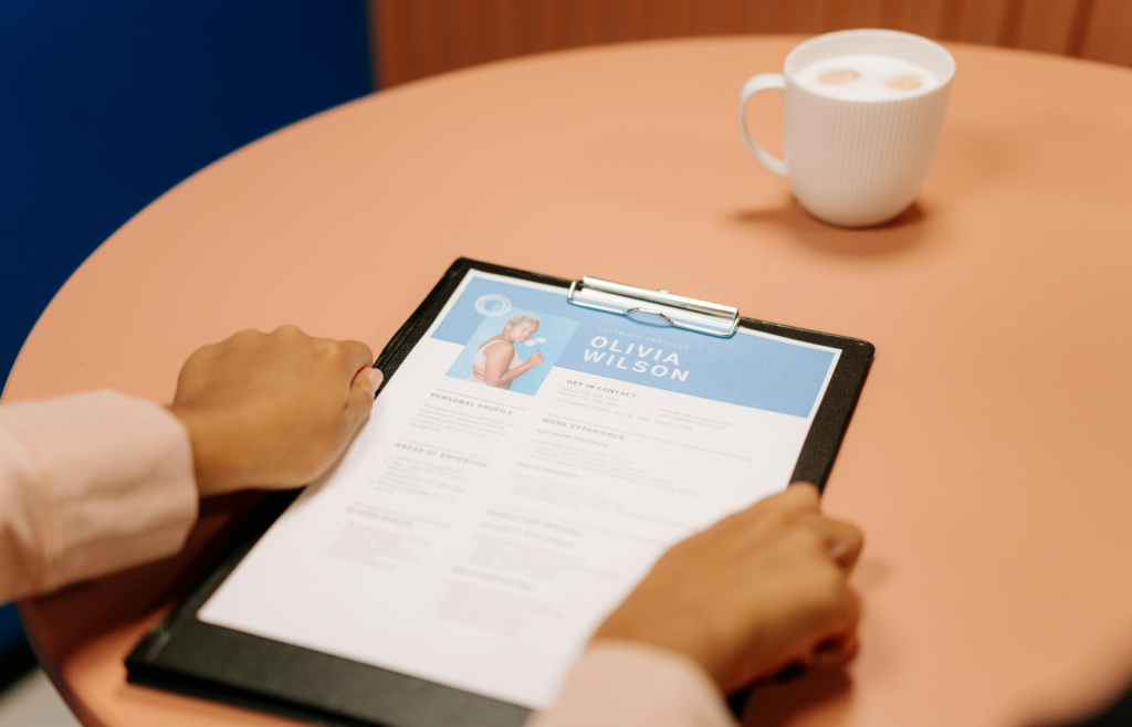 Person Holding Black Tablet and editing their resume