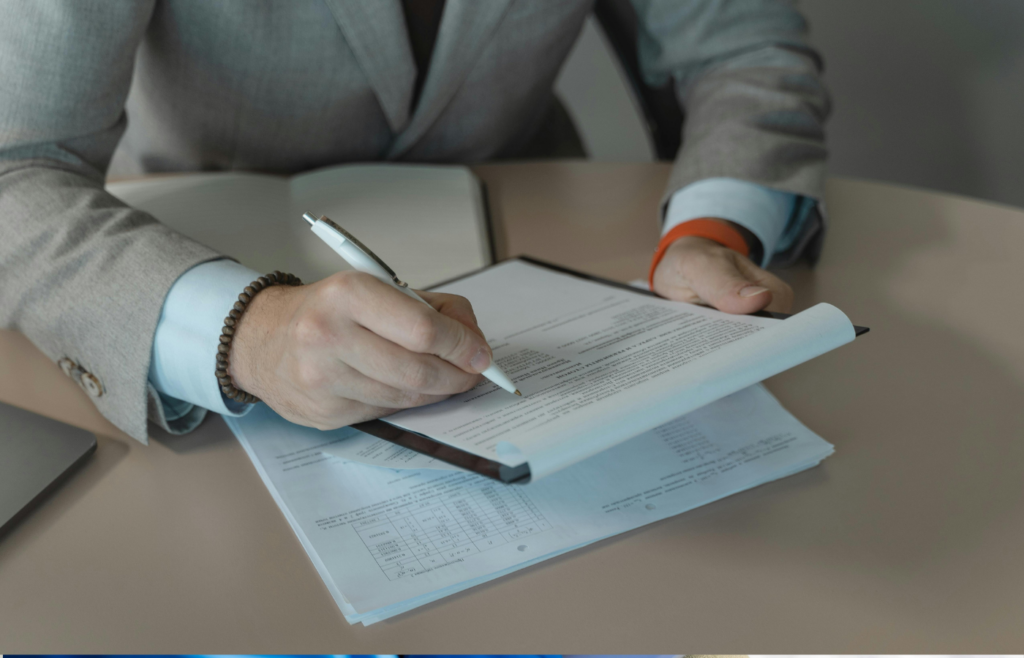 A candidate reviewing resume with a pen