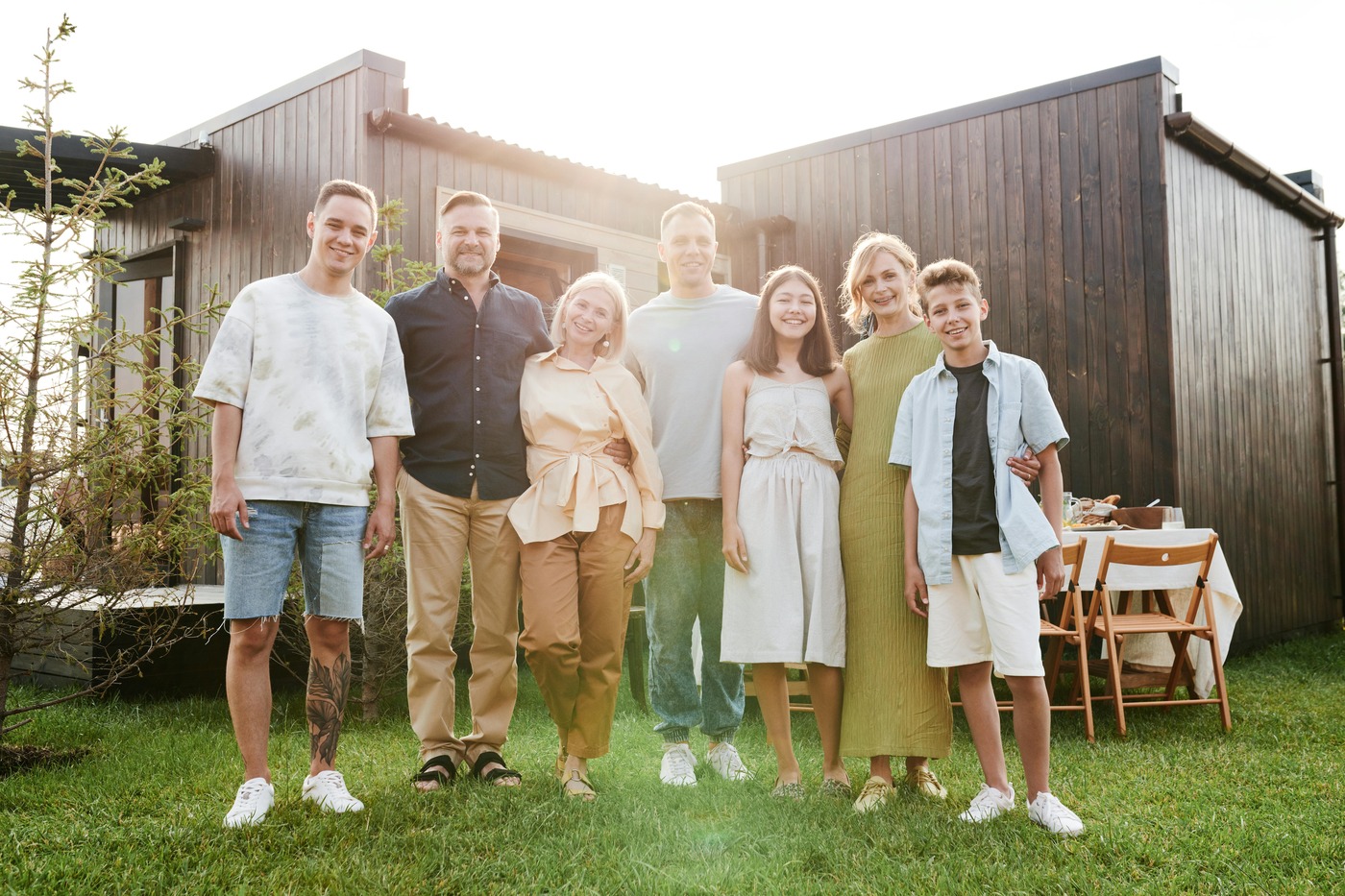 A family standing in front of a HOUSE