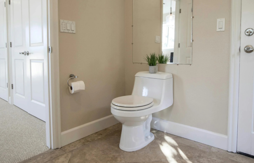 A soft-close toilet seat gently closing in a modern bathroom