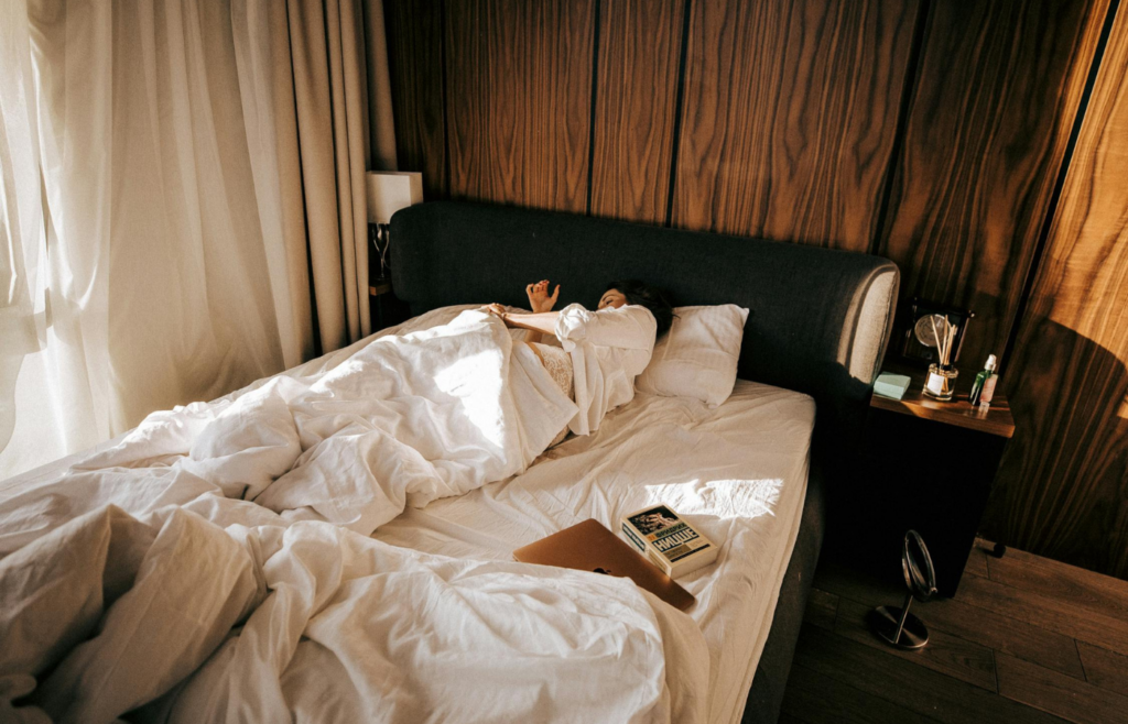 A bedroom with blackout curtains drawn, creating a dark sleeping environment