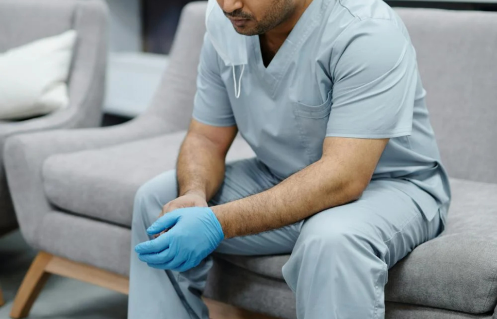 A person feeling guilty while attempting to relax on a couch