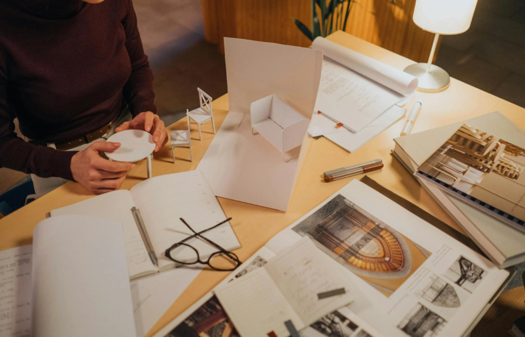 A woman creating model furniture from cardboards