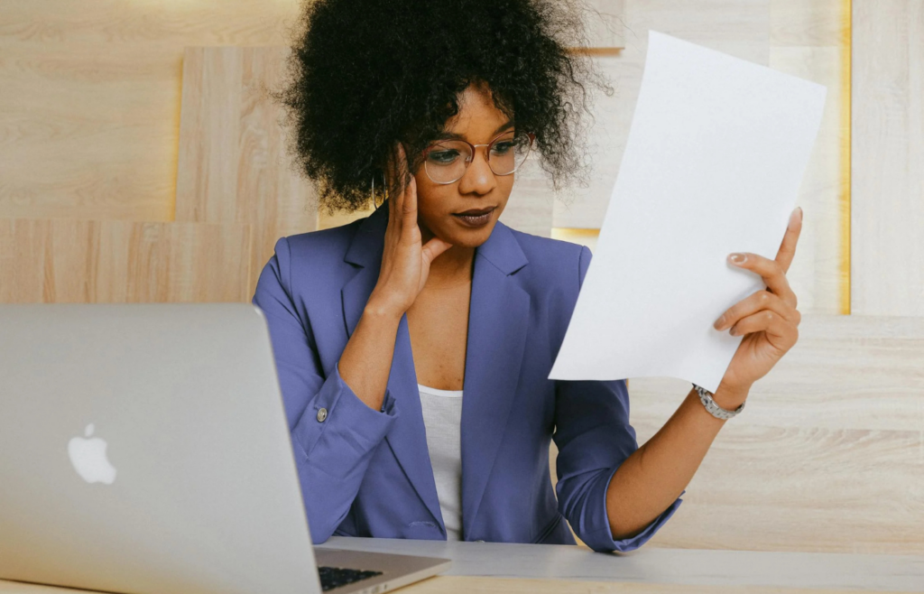 Woman In Blazer Holding White Paper