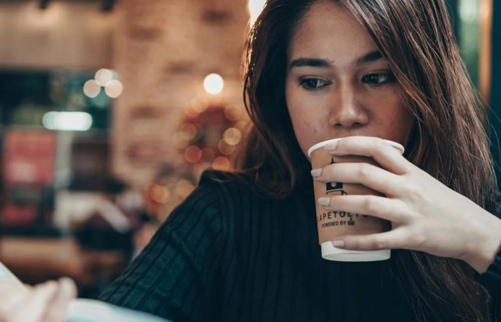 A person reading a book at a cafe