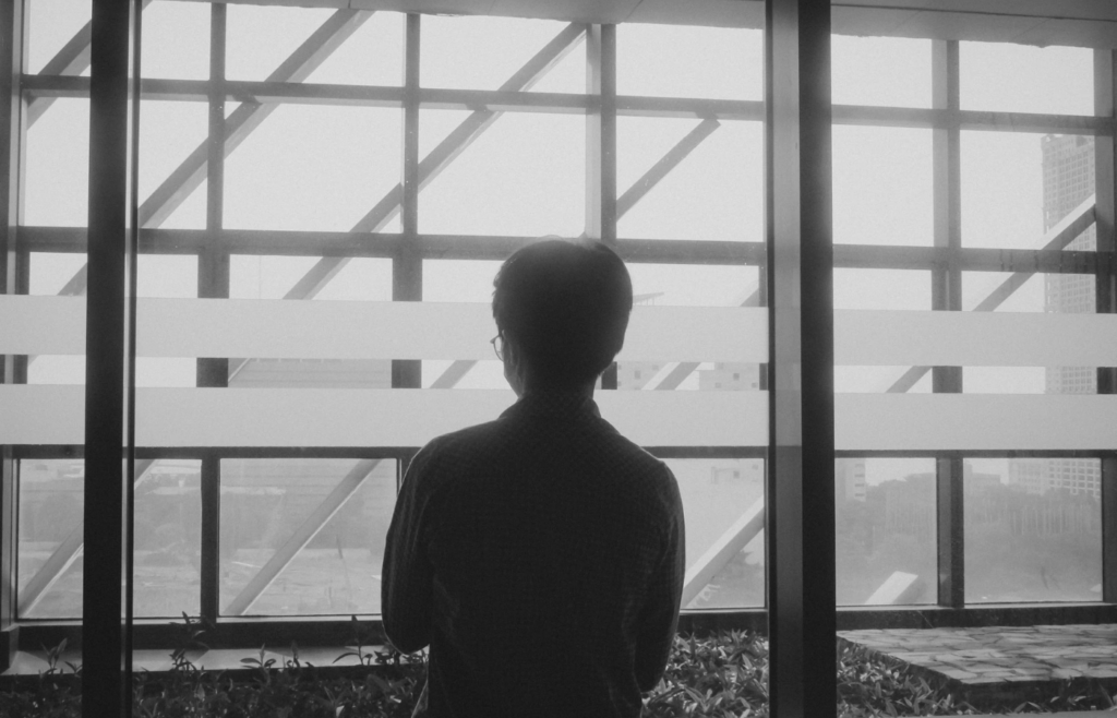 A retiree looking longingly at an office building