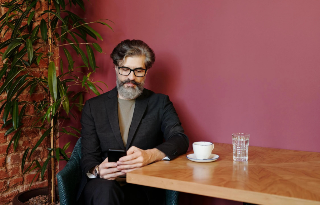 A retiree sitting alone in a café