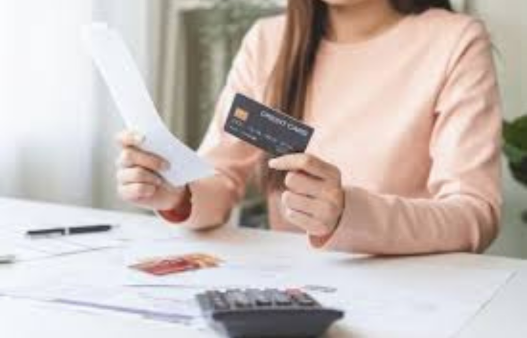 A person surrounded by overdue bills and credit card statements