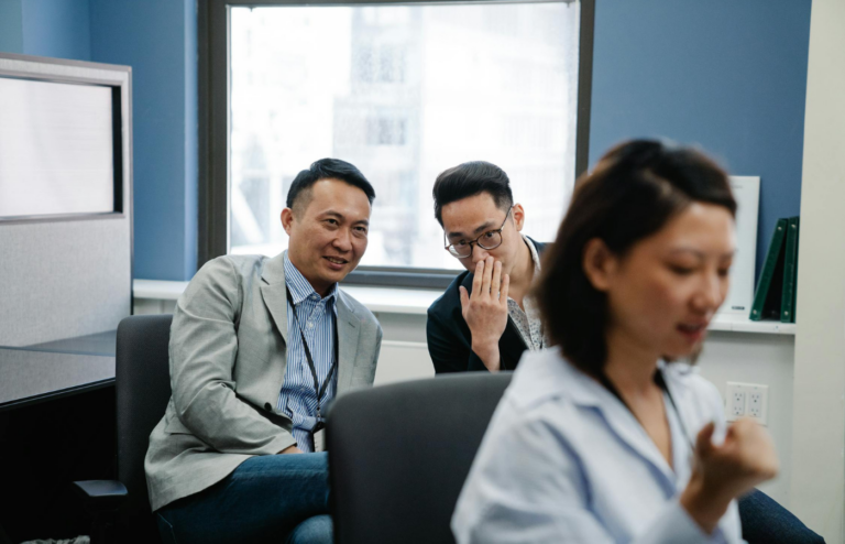 Employees whispering behind a colleague's back