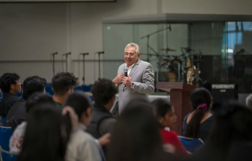A motivational speaker addressing a large audience