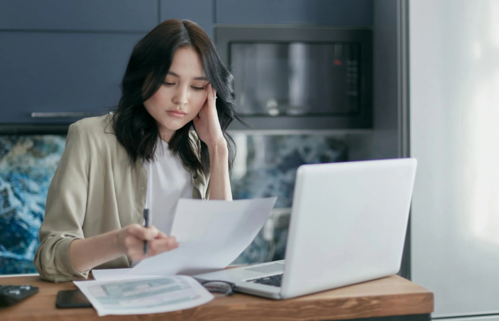 A person overwhelmed by multiple credit card bills