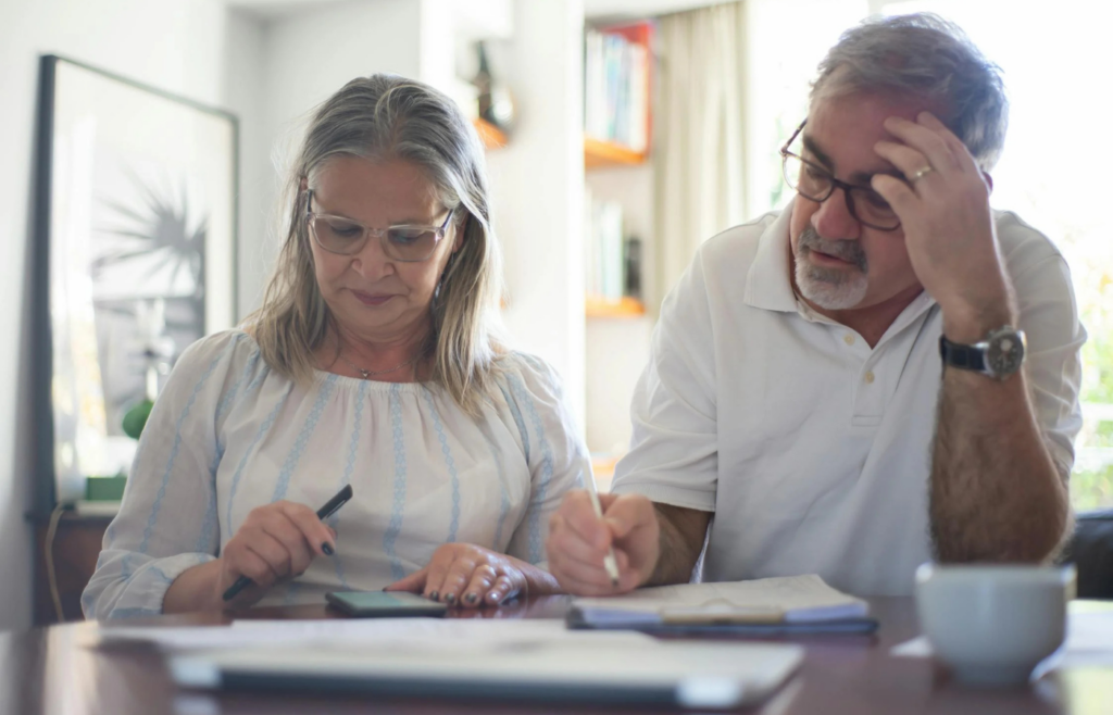 An elderly couple reviewing medical bills
