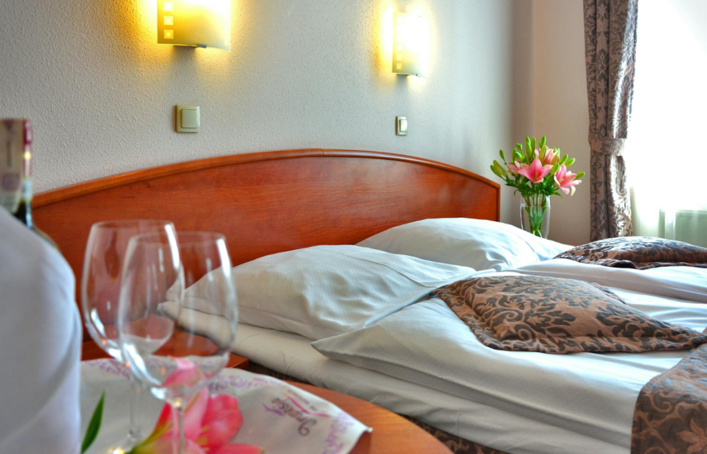 A bed adorned with luxurious, high-thread-count sheets and plush pillows