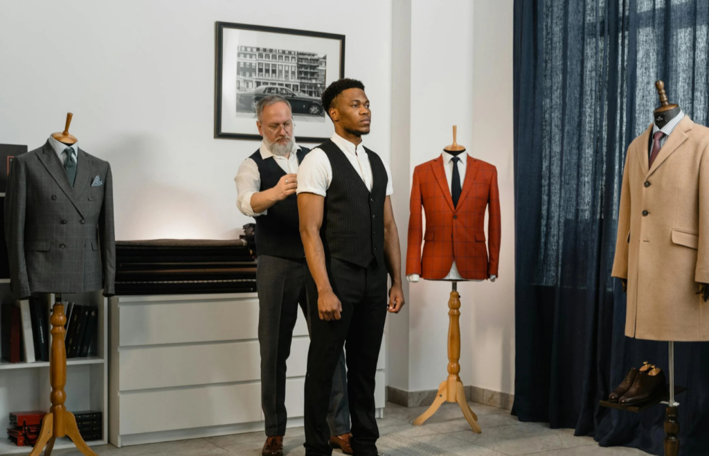A tailor measuring a client for a custom suit