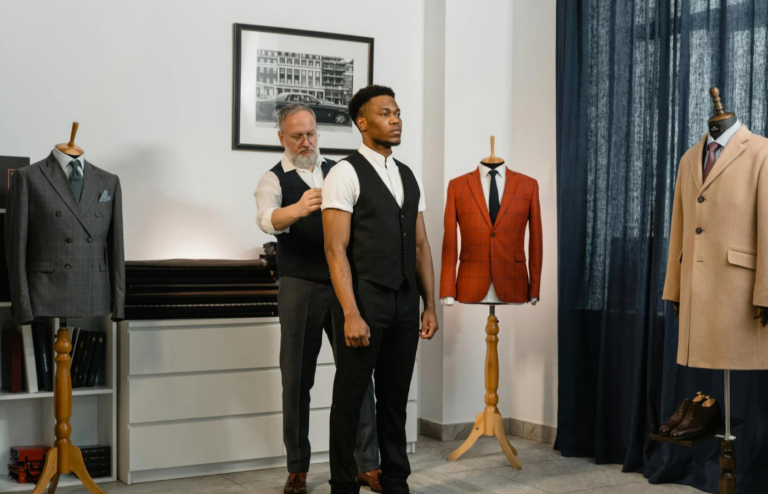 A tailor measuring a client for a custom suit