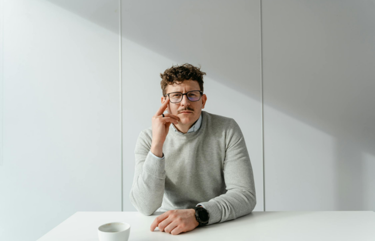 Man in Gray Sweater Wearing Black Framed Eyeglasses
