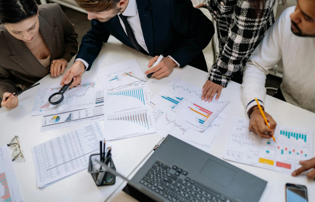 A person diligently planning a budget with charts and graphs