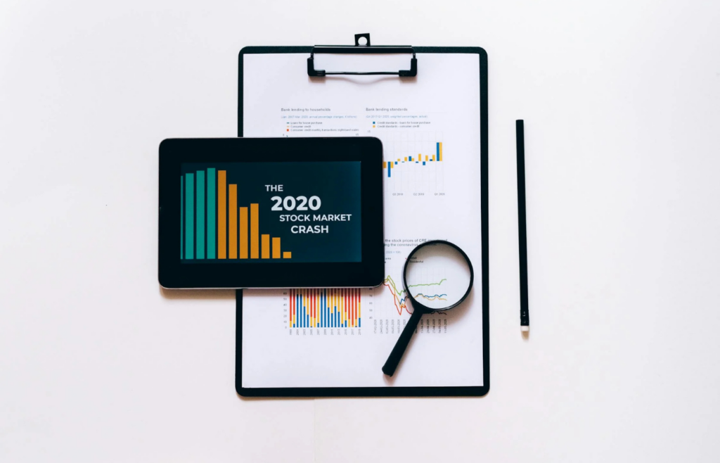 An individual reviewing financial charts on a tablet