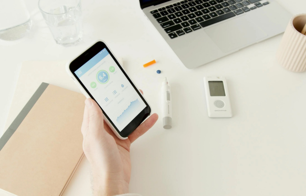 A person checking their smartphone with a budgeting app open